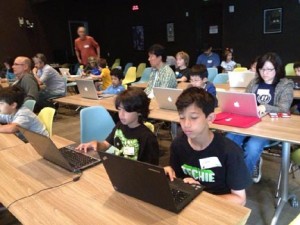 Kids and their parents working on Scratch programs at CoderDojo LA.