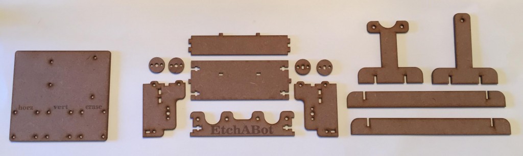 Laser cut wood parts comprise the frame of the EtchABot.
