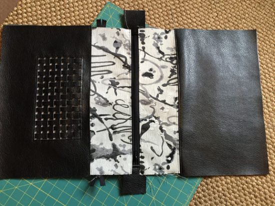 Zipper is sewn in to the front and back of the bag and the lining.